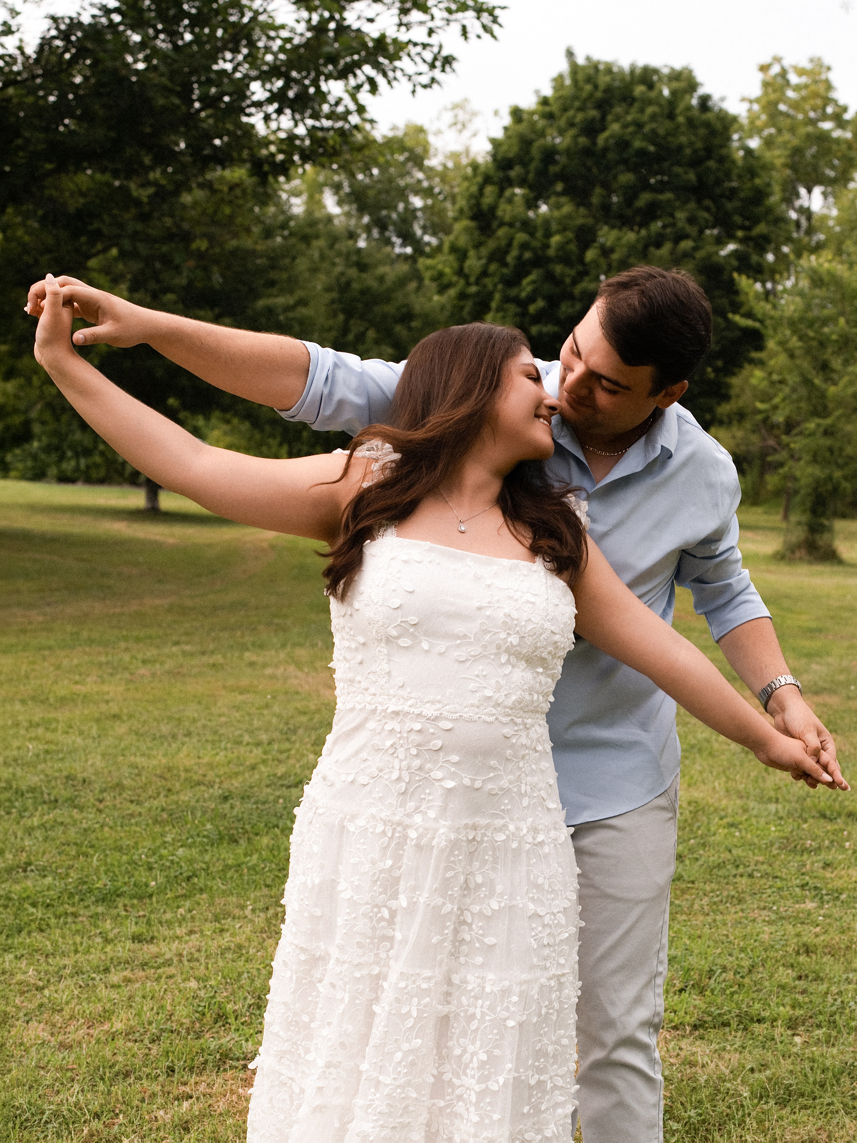 Carolina and Jason dancing together in a field