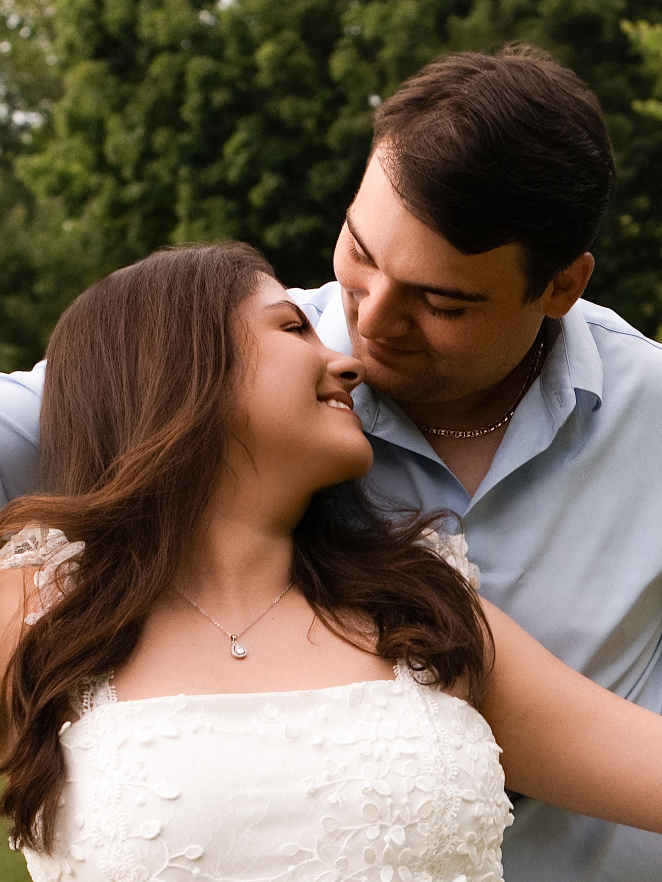 Carolina and Jason sharing a close smile outdoors