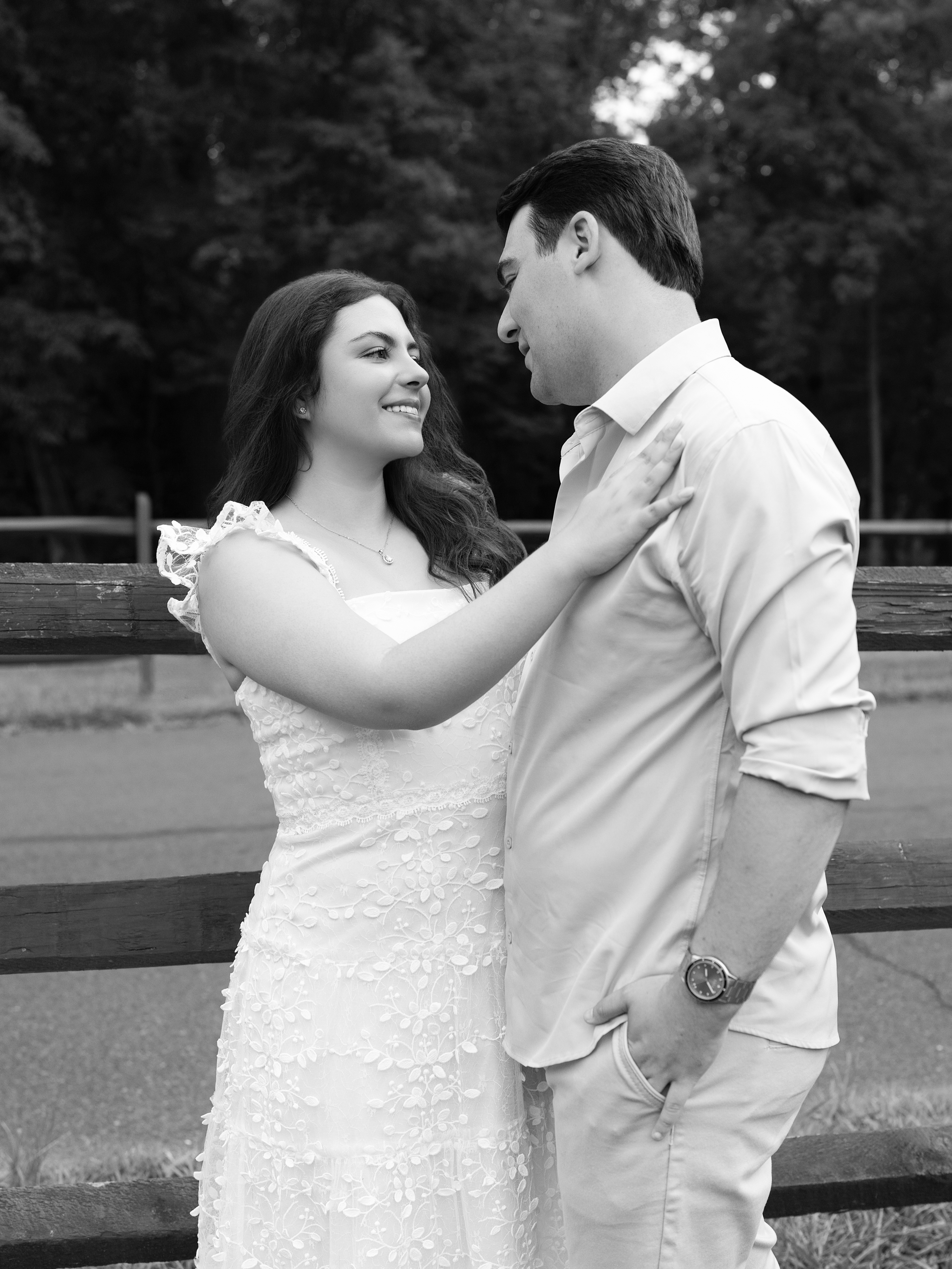 Carolina and Jason looking at each other by a fence
